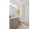Bright bathroom with a bathtub, patterned rug, and stylish vanity at 106 Cottage Gate Ln, Roswell, GA 30076
