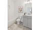Bright bathroom featuring a stylish vanity, toilet, and decorative floral artwork at 106 Cottage Gate Ln, Roswell, GA 30076