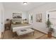 Cozy bedroom with neutral colors, two windows, bedside tables, and stylish artwork at 106 Cottage Gate Ln, Roswell, GA 30076