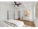 Bright bedroom with neutral colors, ceiling fan, and artwork, creating a serene and inviting atmosphere at 106 Cottage Gate Ln, Roswell, GA 30076