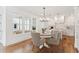 Open-concept dining area with a view of the kitchen and outdoor patio at 106 Cottage Gate Ln, Roswell, GA 30076