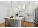 Gourmet kitchen with stainless steel appliances, quartz countertops, and a large island at 106 Cottage Gate Ln, Roswell, GA 30076