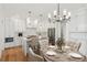 Open concept kitchen boasts sleek white cabinets, stainless steel appliances, and a central island at 106 Cottage Gate Ln, Roswell, GA 30076