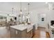 Open kitchen and dining area with hardwood floors and an inviting island at 106 Cottage Gate Ln, Roswell, GA 30076