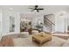 Spacious living room with hardwood floors, an open staircase, and ample natural light at 106 Cottage Gate Ln, Roswell, GA 30076