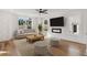 Inviting living room with a fireplace, large windows, and cozy seating area at 106 Cottage Gate Ln, Roswell, GA 30076
