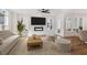 Cozy living room with fireplace, ceiling fan, hardwood floors, and neutral decor at 106 Cottage Gate Ln, Roswell, GA 30076