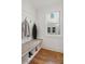 Mudroom with storage bench, coat hooks, and a window that offers natural light and street view at 106 Cottage Gate Ln, Roswell, GA 30076