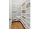 Walk-in pantry with ample shelving for storage, and wood floors at 106 Cottage Gate Ln, Roswell, GA 30076