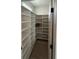 Walk-in pantry with white shelving perfect for storage and organization at 106 Cottage Gate Ln, Roswell, GA 30076