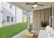 Covered patio with ceiling fan, table and seating, with view of the manicured lawn at 106 Cottage Gate Ln, Roswell, GA 30076
