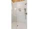 Modern walk-in shower with marble tile, rainfall shower head, and glass door at 106 Cottage Gate Ln, Roswell, GA 30076
