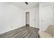 Small bedroom with gray floors, white walls, closet and door leading to another room at 1392 Shoreham Dr, Atlanta, GA 30349