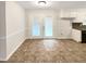 Bright dining area featuring vinyl floors and double doors to the exterior at 1665 Ridgeview Nw Dr, Conyers, GA 30012
