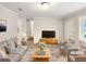 Bright living room with neutral walls, two couches and chairs, and a large rug; a perfect space for relaxing and entertaining at 1665 Ridgeview Nw Dr, Conyers, GA 30012