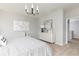 Calm bedroom with a modern chandelier, neutral dresser, and open door leading to hallway at 428 Madison Lakeview Dr, Acworth, GA 30102