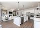 Open-concept living area with a modern kitchen featuring stainless steel appliances and a spacious island at 428 Madison Lakeview Dr, Acworth, GA 30102