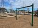 Community playground with swings surrounded by lush lawns and beautiful homes in the background at 428 Madison Lakeview Dr, Acworth, GA 30102