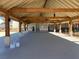 Interior view of a community pool house with a covered area, ceiling fans, and concrete flooring at 428 Madison Lakeview Dr, Acworth, GA 30102