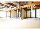 Unfinished basement with exposed ceiling, duct work, concrete flooring, and solid support beams at 900 King Rd, Jonesboro, GA 30236