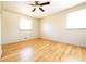 Bright bedroom featuring hardwood floors, neutral walls, ceiling fan, and natural light from two windows at 900 King Rd, Jonesboro, GA 30236