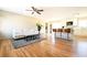 Open-concept living room with hardwood floors, white sofa, and kitchen with island seating at 900 King Rd, Jonesboro, GA 30236