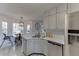 Well-lit kitchen features white cabinets, modern appliances, and hardwood floors at 2920 Summit Point Ct, Snellville, GA 30078