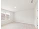 Bright bedroom with plush carpet, window and fresh white walls at 5526 Rosehall Pl, Atlanta, GA 30349
