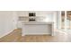 Bright kitchen featuring white cabinetry, stainless steel appliances, granite countertops, a center island, and sliding glass doors at 5526 Rosehall Pl, Atlanta, GA 30349