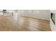 Spacious living room with hard wood floors, a modern fireplace, and windows that let in ample natural light at 5526 Rosehall Pl, Atlanta, GA 30349
