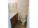 Compact bathroom featuring a vanity with a marble countertop and a toilet at 770 Parkway Rd, Union City, GA 30291