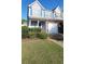 Inviting townhome exterior featuring a one-car garage and manicured front yard at 770 Parkway Rd, Union City, GA 30291