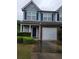 Charming two-story townhome with blue siding, garage, well-manicured lawn, and inviting front door at 770 Parkway Rd, Union City, GA 30291
