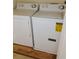 Laundry room with full sized washer and dryer, laminate flooring at 770 Parkway Rd, Union City, GA 30291