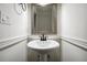 Small pedestal sink features framed mirror, brushed bronze fixtures, and white walls at 2977 Heritage Villas Dr, Lithonia, GA 30038