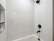 Bathtub with a white tile surround, recessed niche, and matte black hardware at 2977 Heritage Villas Dr, Lithonia, GA 30038