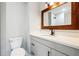 Bathroom vanity with a rustic wood mirror, white countertop and toilet at 2977 Heritage Villas Dr, Lithonia, GA 30038