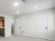 Bedroom features neutral carpet, white walls, recessed lighting, and a door to a bathroom at 2977 Heritage Villas Dr, Lithonia, GA 30038