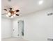 White bedroom with carpet, ceiling fan and a door that leads to the basement at 2977 Heritage Villas Dr, Lithonia, GA 30038