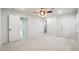 Spacious bedroom with carpet, ceiling fan, and white walls with many doors at 2977 Heritage Villas Dr, Lithonia, GA 30038