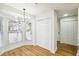 Bright dining area with wood floors, modern light fixture and access to lots of closet space at 2977 Heritage Villas Dr, Lithonia, GA 30038