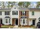 Charming townhome featuring a brick facade, black shutters, and a well-manicured lawn at 2977 Heritage Villas Dr, Lithonia, GA 30038