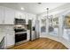 Eat-in kitchen featuring stainless steel appliances, marble backsplash, and lots of natural light at 2977 Heritage Villas Dr, Lithonia, GA 30038