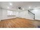 Living room with a ceiling fan, wood floors, and a view into the kitchen at 2977 Heritage Villas Dr, Lithonia, GA 30038