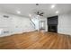 Bright living room with a fireplace, ceiling fan, and beautiful wood flooring at 2977 Heritage Villas Dr, Lithonia, GA 30038