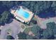 Overhead view of a community pool, lounge area and tennis court surrounded by lush trees at 3125 Colonial Way # H, Atlanta, GA 30341