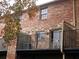 View of the brick exterior featuring a fenced balcony with sliding glass doors at 3125 Colonial Way # H, Atlanta, GA 30341