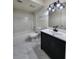 Modern bathroom with sleek vanity, tub-shower combo, and stylish marble flooring at 3125 Colonial Way # H, Atlanta, GA 30341