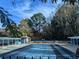 Community pool surrounded by a fence and covered seating with the clubhouse in the background at 3125 Colonial Way # H, Atlanta, GA 30341