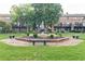 View of a well-maintained courtyard featuring a tiered fountain, benches, and landscaping at 3125 Colonial Way # H, Atlanta, GA 30341